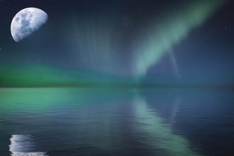 Image of a moon reflected on the ocean