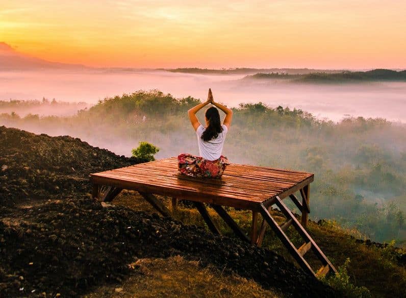 Image of a woman doing a yoga pose learning how to ground yourself