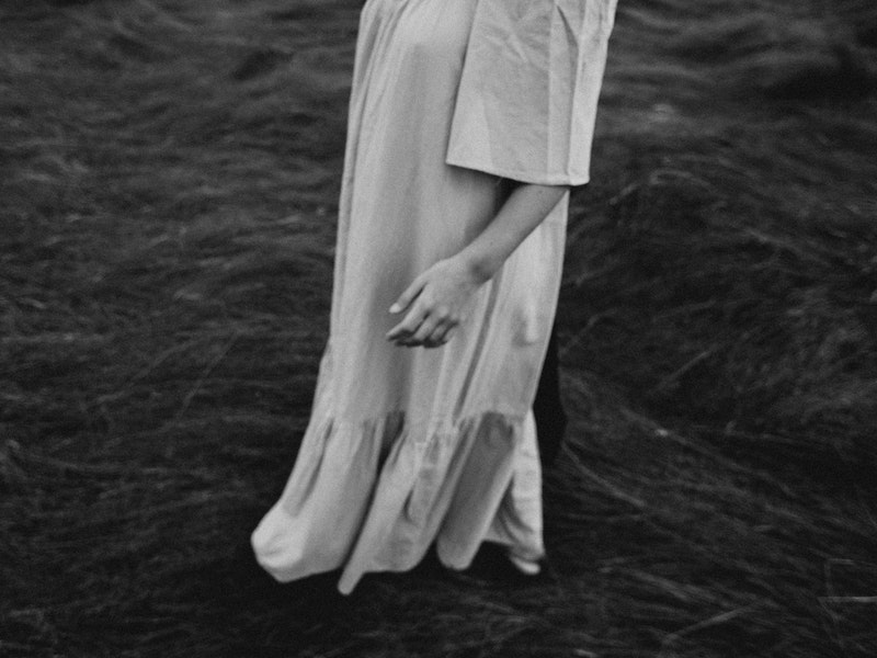 Image of a woman in a white dress in a paddock