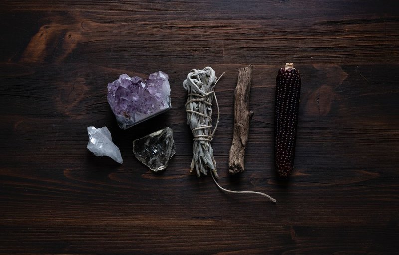 Image of crystals, sage smudge stick, and shamanic objects