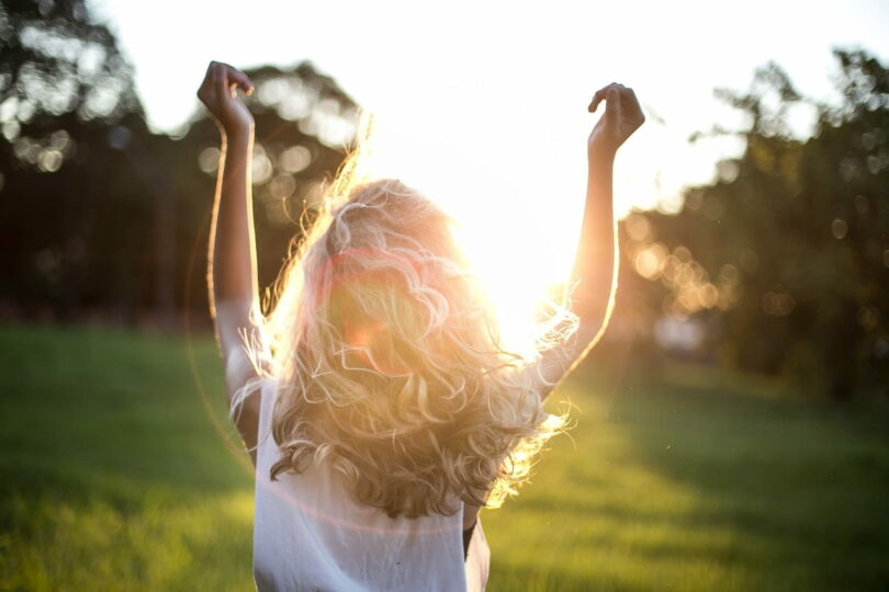 Image of a woman dancing in the sun representing embodied spirituality