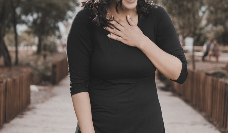 Image of a woman putting a hand over her heart