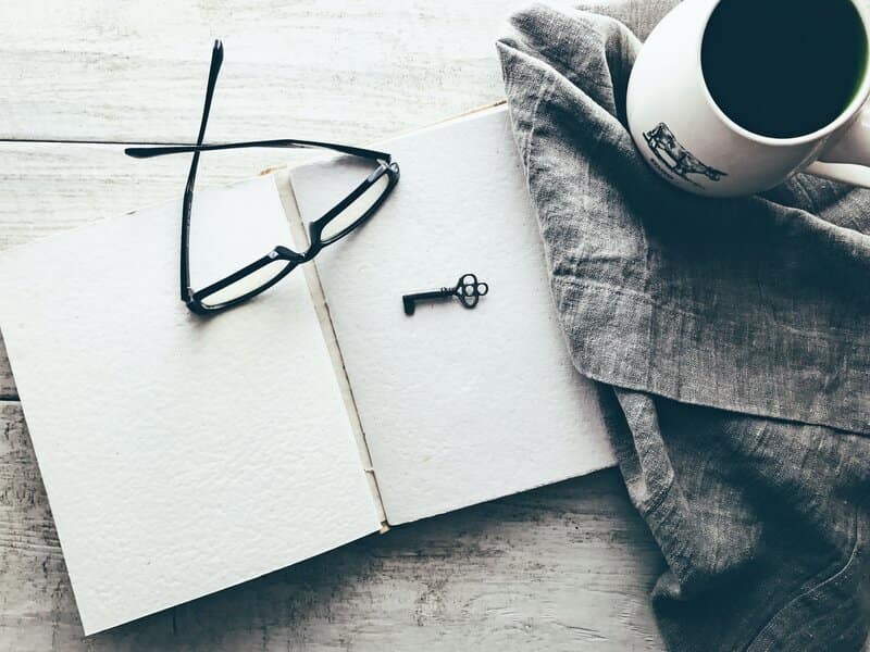 Image of an open journal next to a cup of coffee