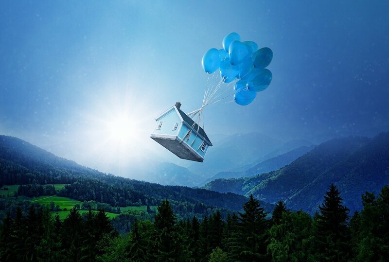 Image of a house attached to balloons flying away