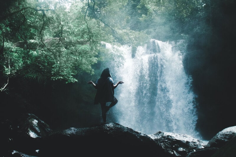 Image of a woman meditating and doing yoga in nature