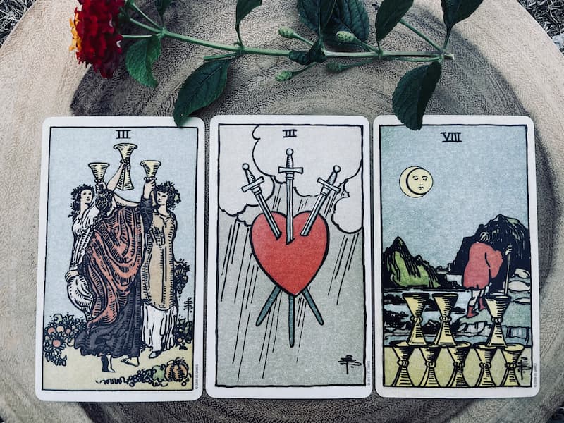 Image of three tarot cards that depict losing friends
