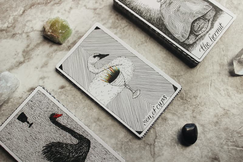 Image of tarot cards on a marble table with some stones