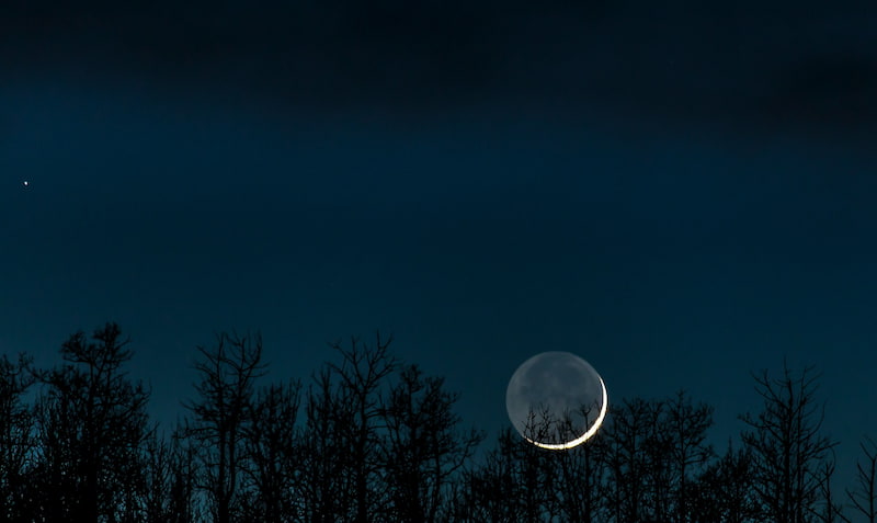 Image of a black moon in the night sky