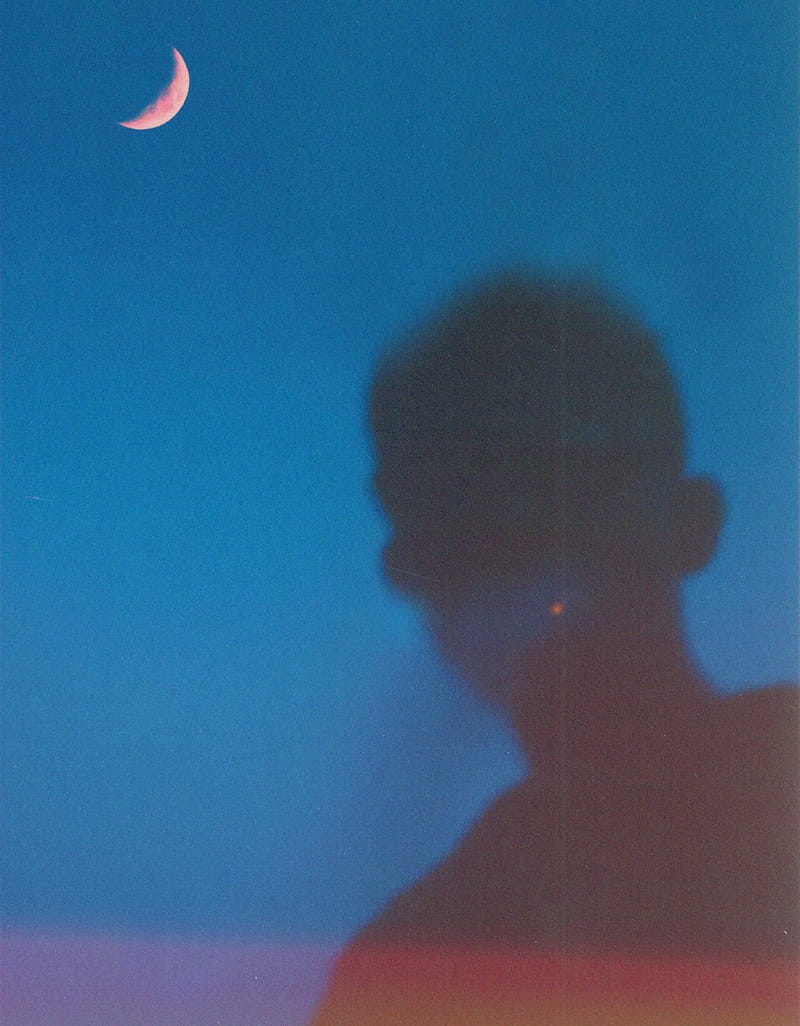 Image of a lone wolf empath man beneath the moon