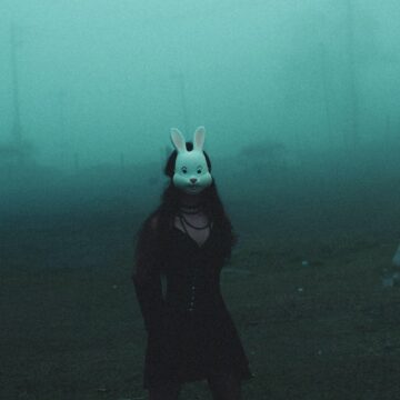 Image of a person wearing a rabbit mask who is trying to be normal but is experiencing soul loss