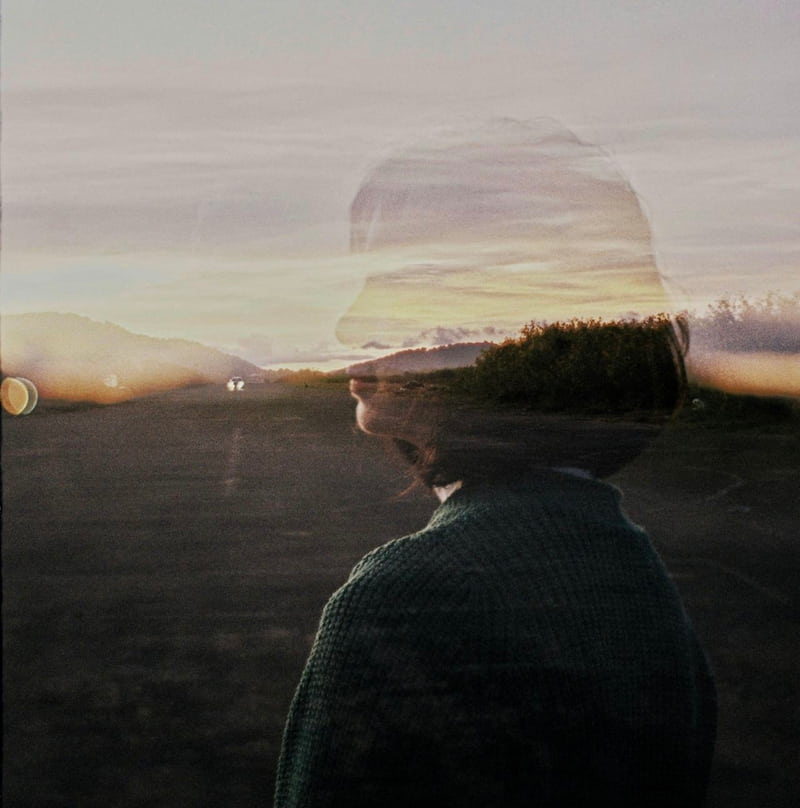 Image of a double exposure photo of a woman standing on a high way symbolic of setting boundaries that don't last