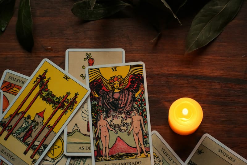 Image of tarot cards on a table with a candle