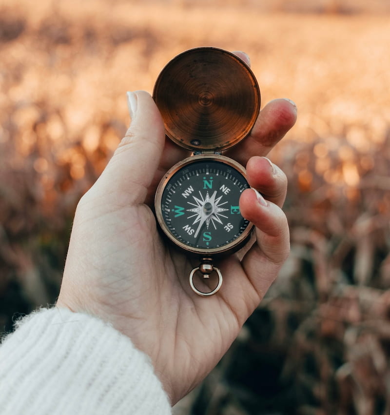 Image of a woman holding a compass
