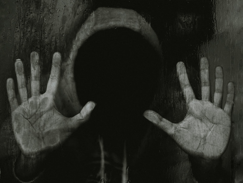 Image of a person wearing a hoodie with a black void for a face symbolizing soul loss in the age of AI