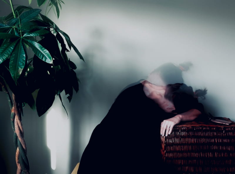 Image of a woman grieving indoors