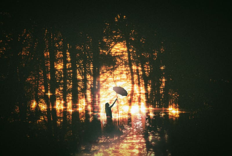 Image of a person holding an umbrella in the rain