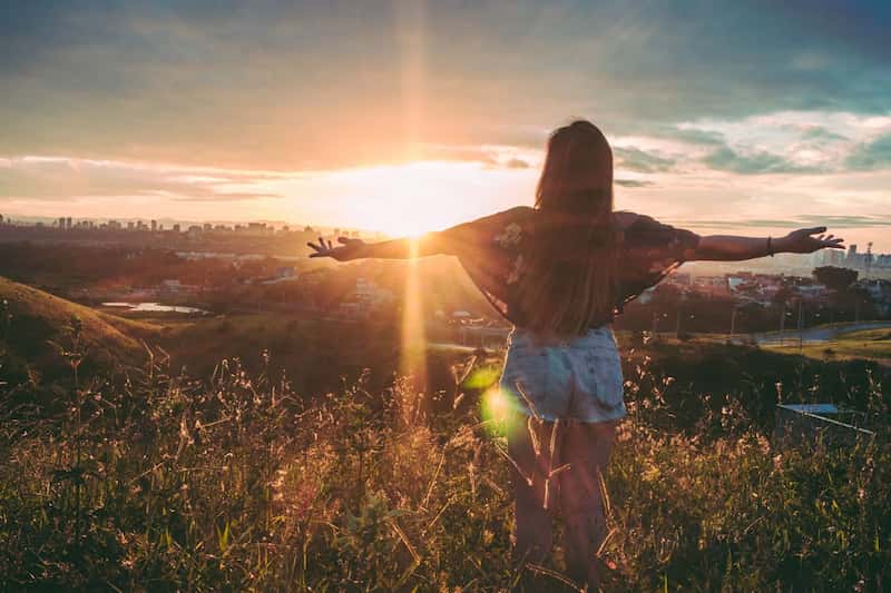 image of a woman with her arms wide practicing radical acceptance
