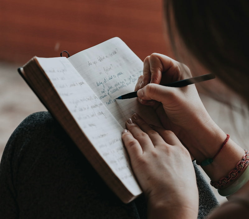the image of a woman keeping a journal symbolizes self-determination