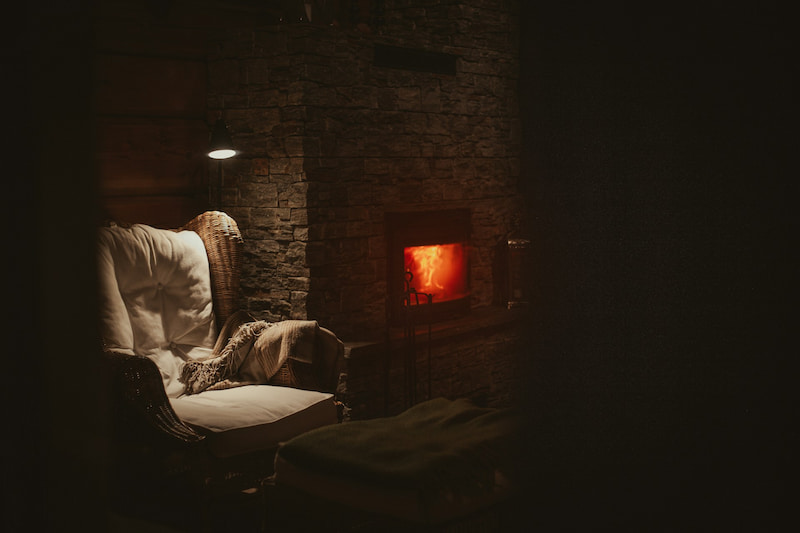 image of a chair next to a fireplace